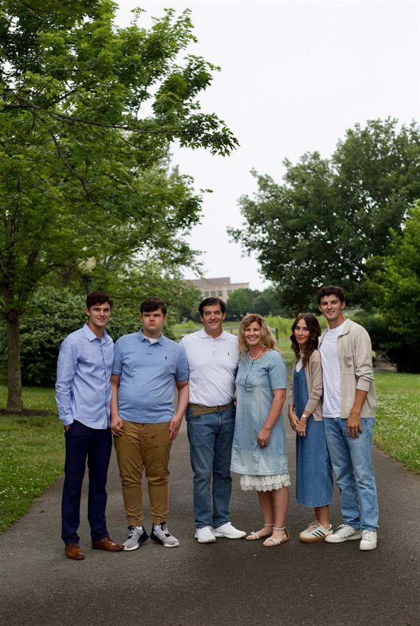 Six people standing together on a park path