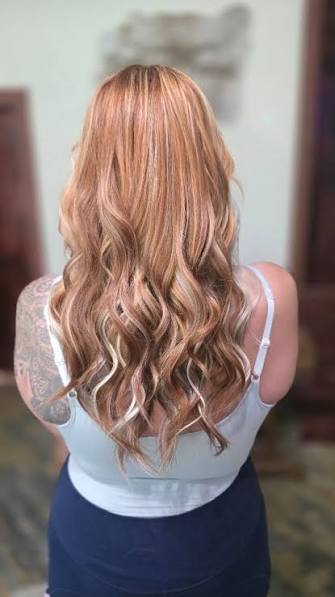 Long wavy blond hair shown from the back