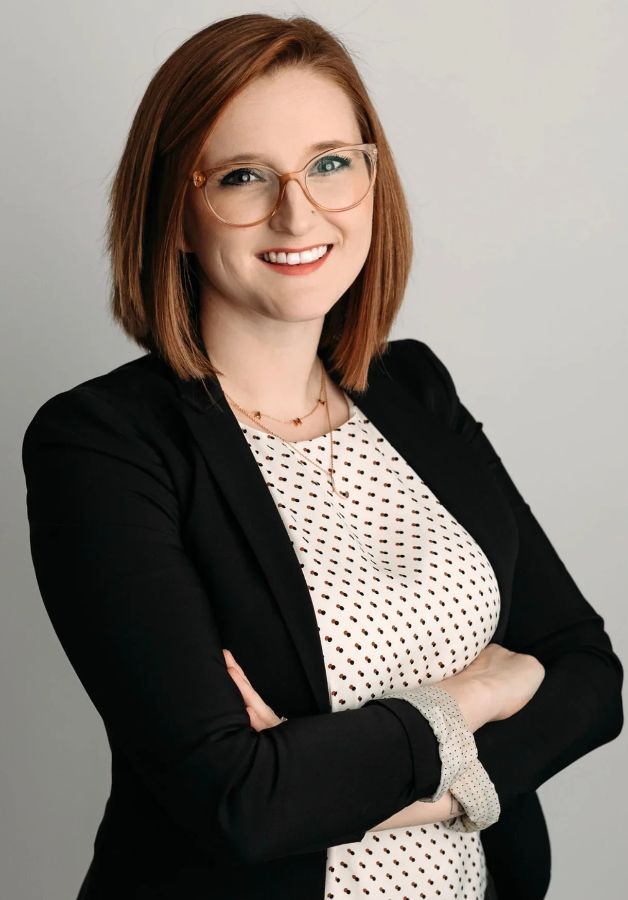 Mercedes Lawson smiling in a dark blazer and polka-dot top